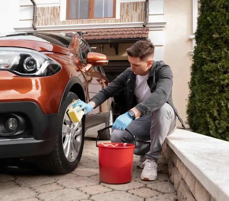 Lavage auto à domicile Saint-Léger-du-Bois : professionnel intervenant sur un véhicule